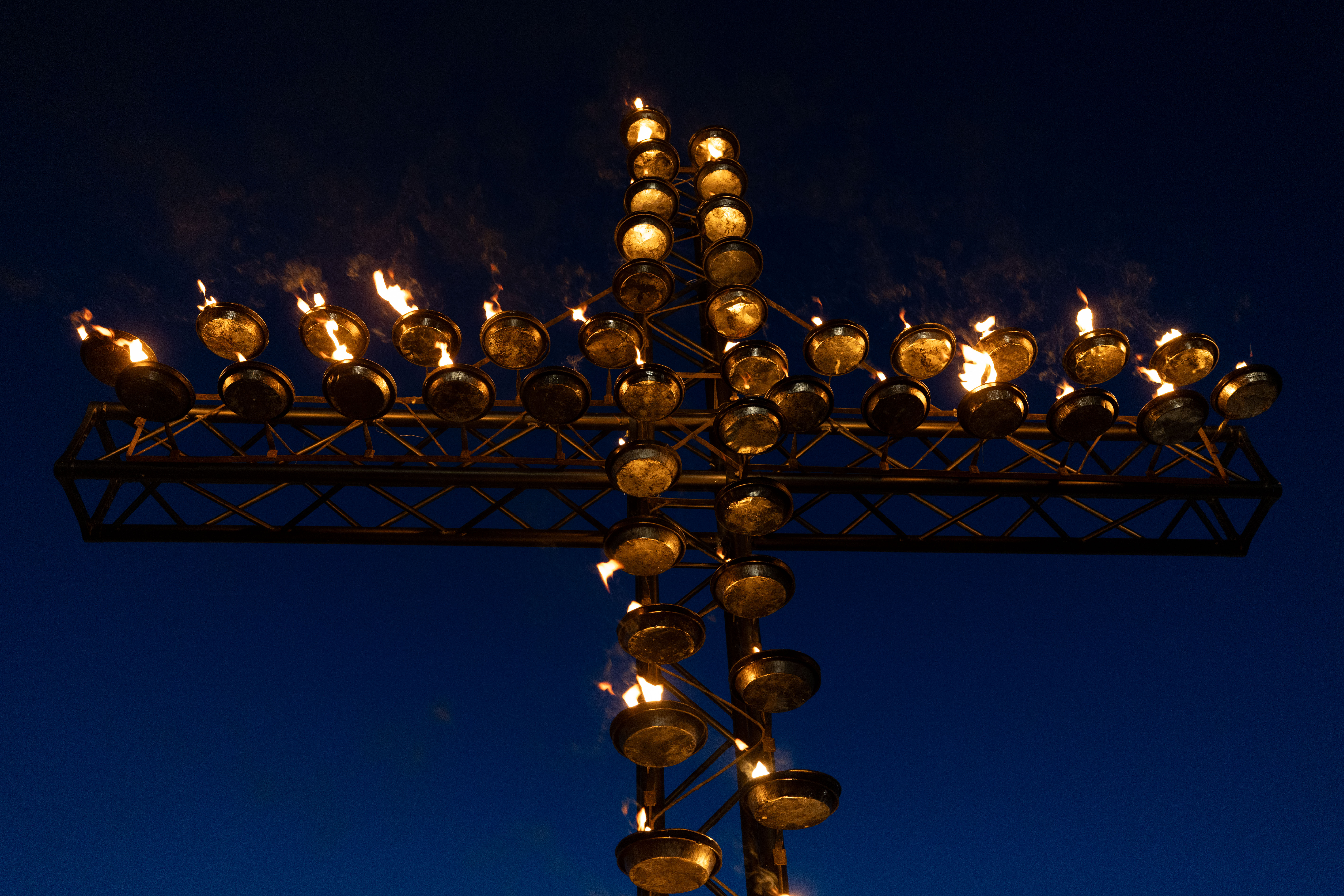 A flickering cross towers at the Colosseum in Rome on Good Friday, April 3, 2026. | Credit: Daniel Ibáñez/EWTN News