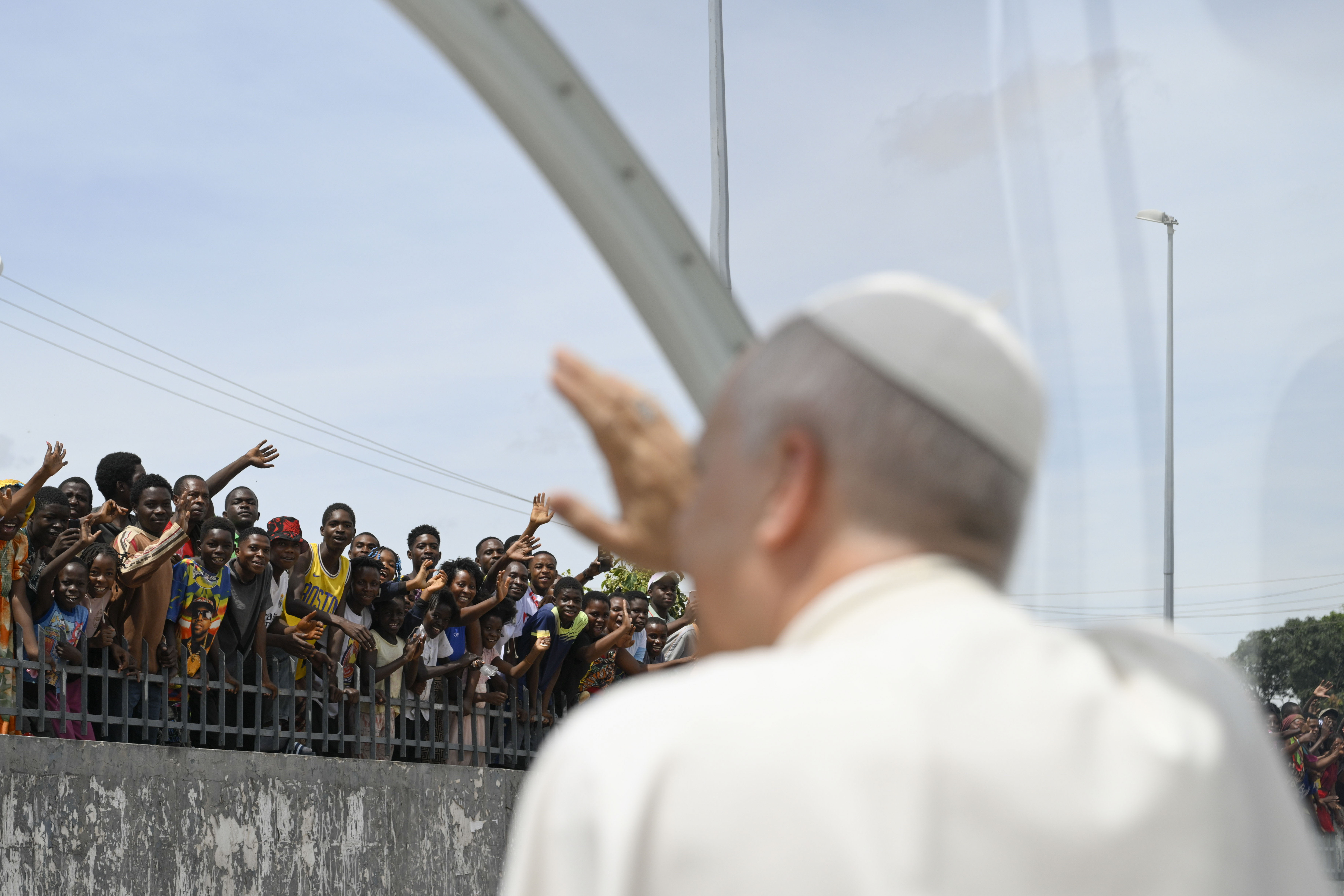 Pope Leo XIV waves to the crowds before celebrating Mass in Saurimo, Angola, on April 20, 2026. Despite the intense heat, upon reaching the esplanade before Mass, Leo XIV greeted the roughly 60,000 faithful of all ages — who had come from across the region and neighboring dioceses — by making a circuit in the popemobile. | Credit: Vatican Media