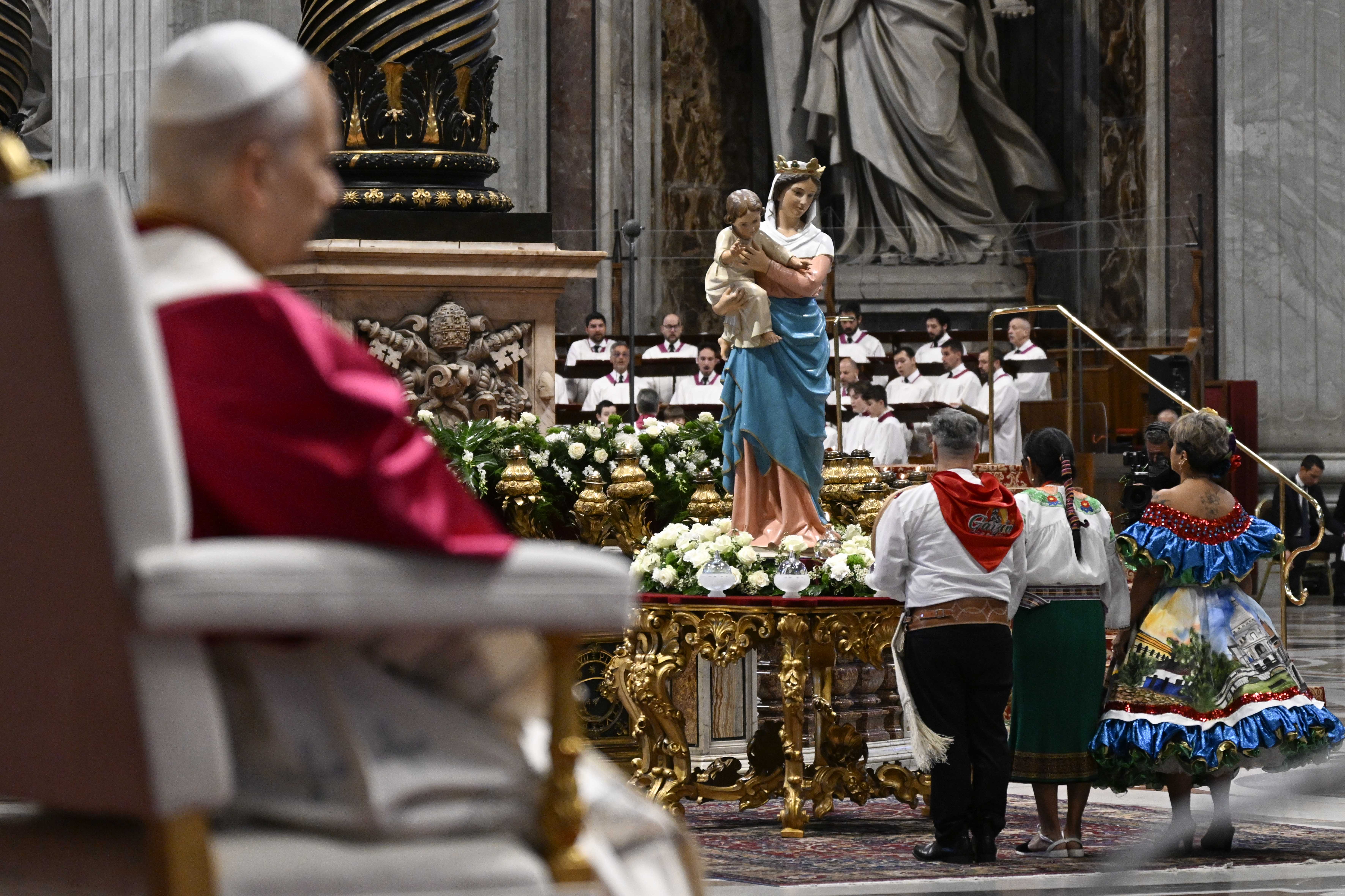 Continental delegates light a candle at the foot of a statue of the Blessed Mother during a peace vigil at St. Peterʼs Basilica, Saturday, Apr. 11, 2026. | Credit: Vatican Media