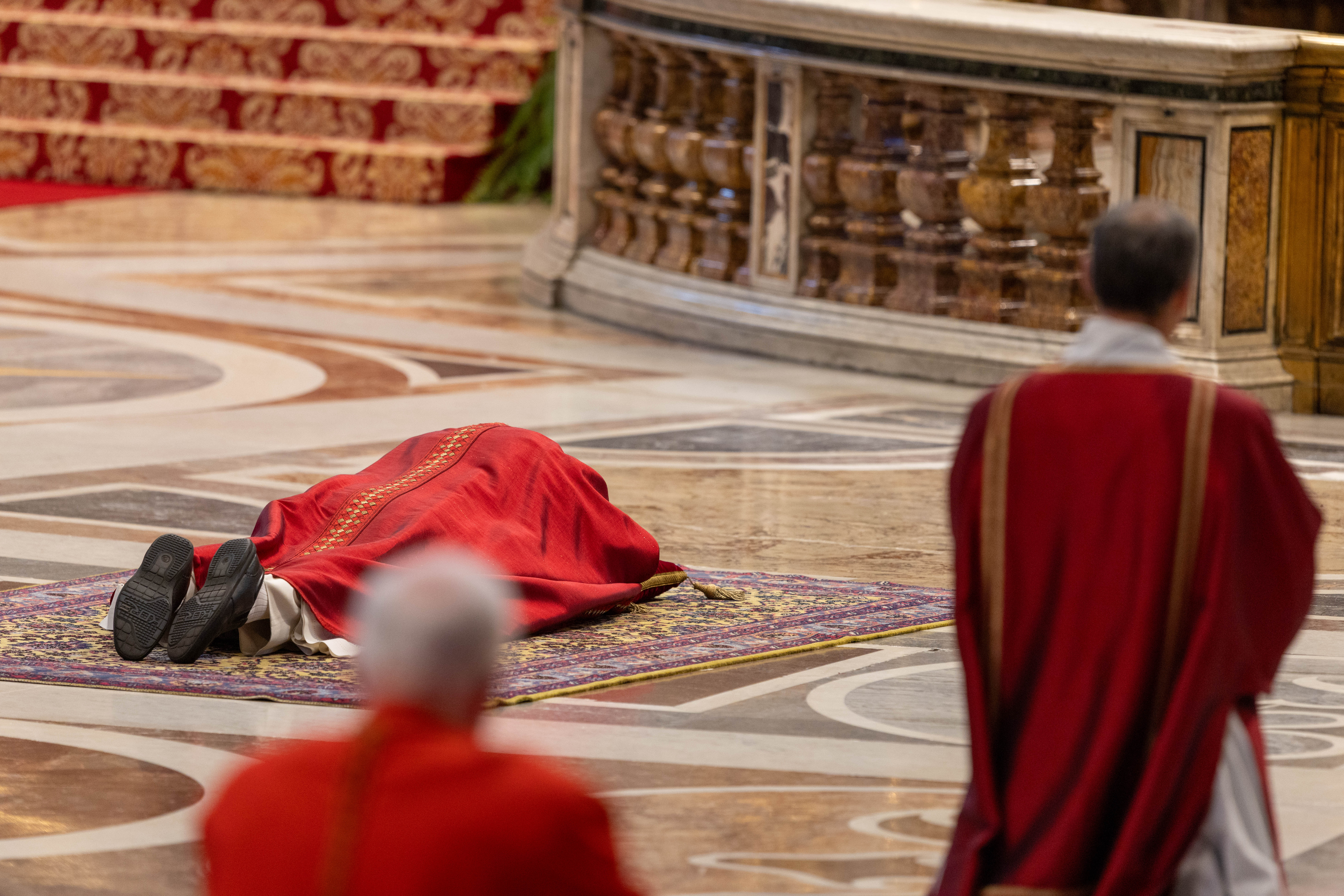 Pope Leo XIV lies prostrate before the altar in St. Peter’s Basilica during the Liturgy of the Lord’s Passion, Friday, April 3, 2026. | Credit: Daniel Ibáñez/EWTN News