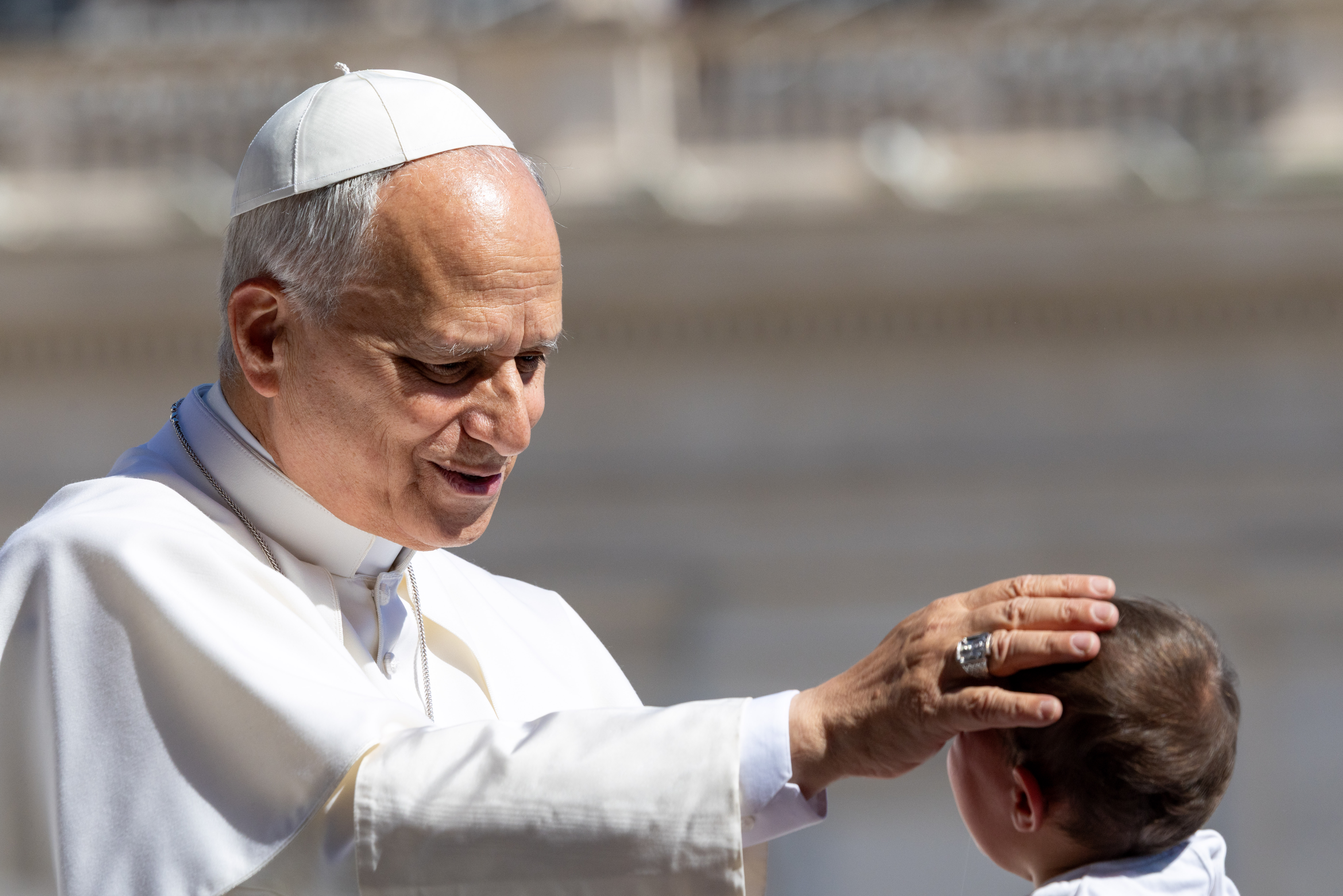 Pope Leo XIV blesses a baby in St. Peter’s Square during the general audience on May 27, 2026. The pope spoke about the Second Vatican Council and the need for priests to follow liturgical norms. | Credit: Daniel Ibáñez/EWTN News