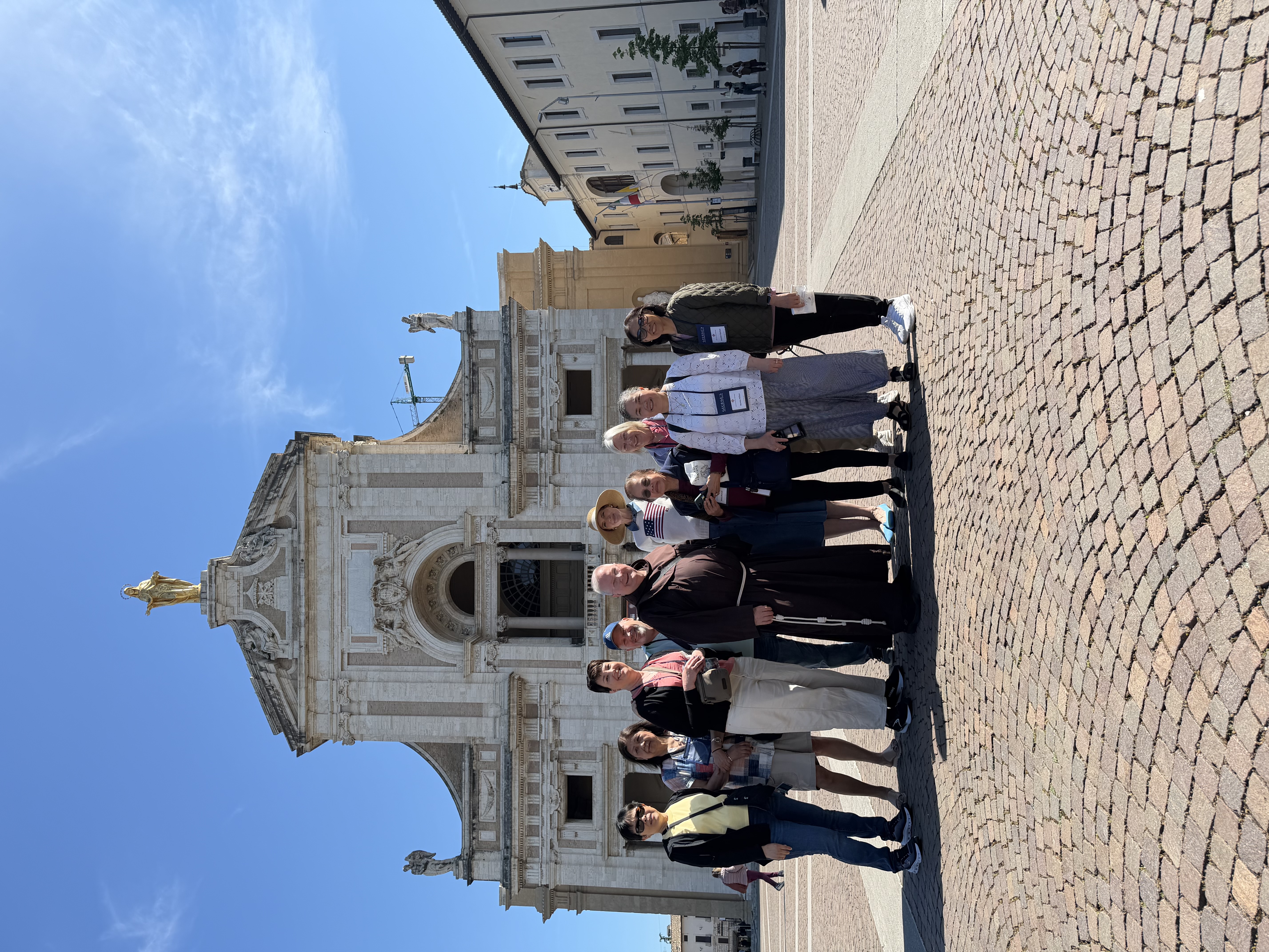 Pilgrims outside the Basilica of St. Mary of Angels, which houses the Portiuncula, in Assisi, Italy. | Credit: Stephanie Green
