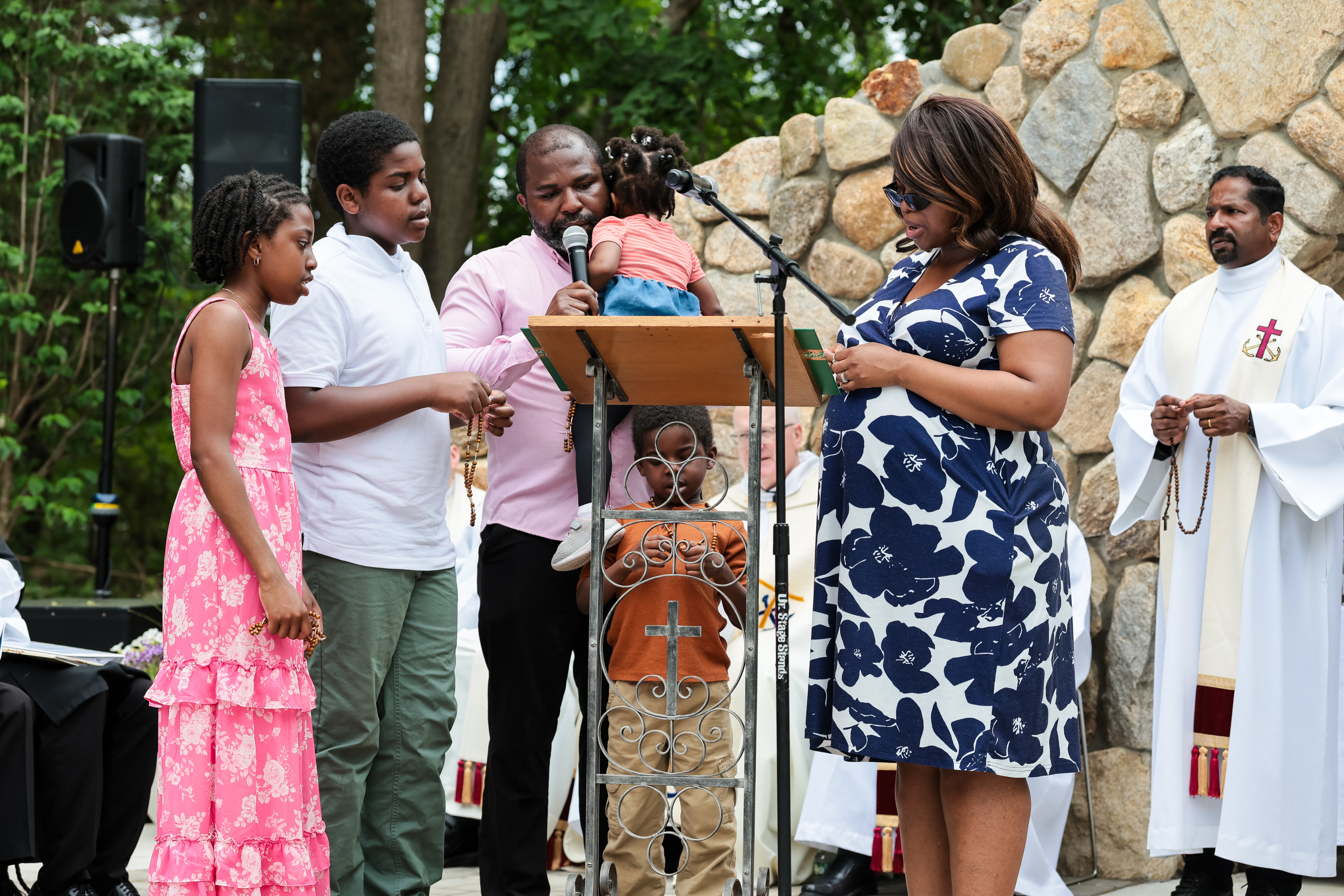A family prays a decade of the rosary at the opening of the Father Peyton Center. | Credit: Photo courtesy of Holy Cross Family Ministries