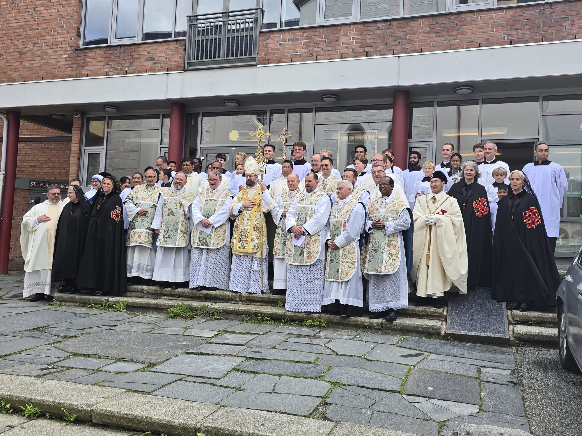Bishop Fredrik Hansen, flanked by priests, religious sisters, and altar servers, stands outside St. Paul’s Church following its consecration in Bergen, Norway, on June 28, 2026. | Credit: Hoang Van Nguyen