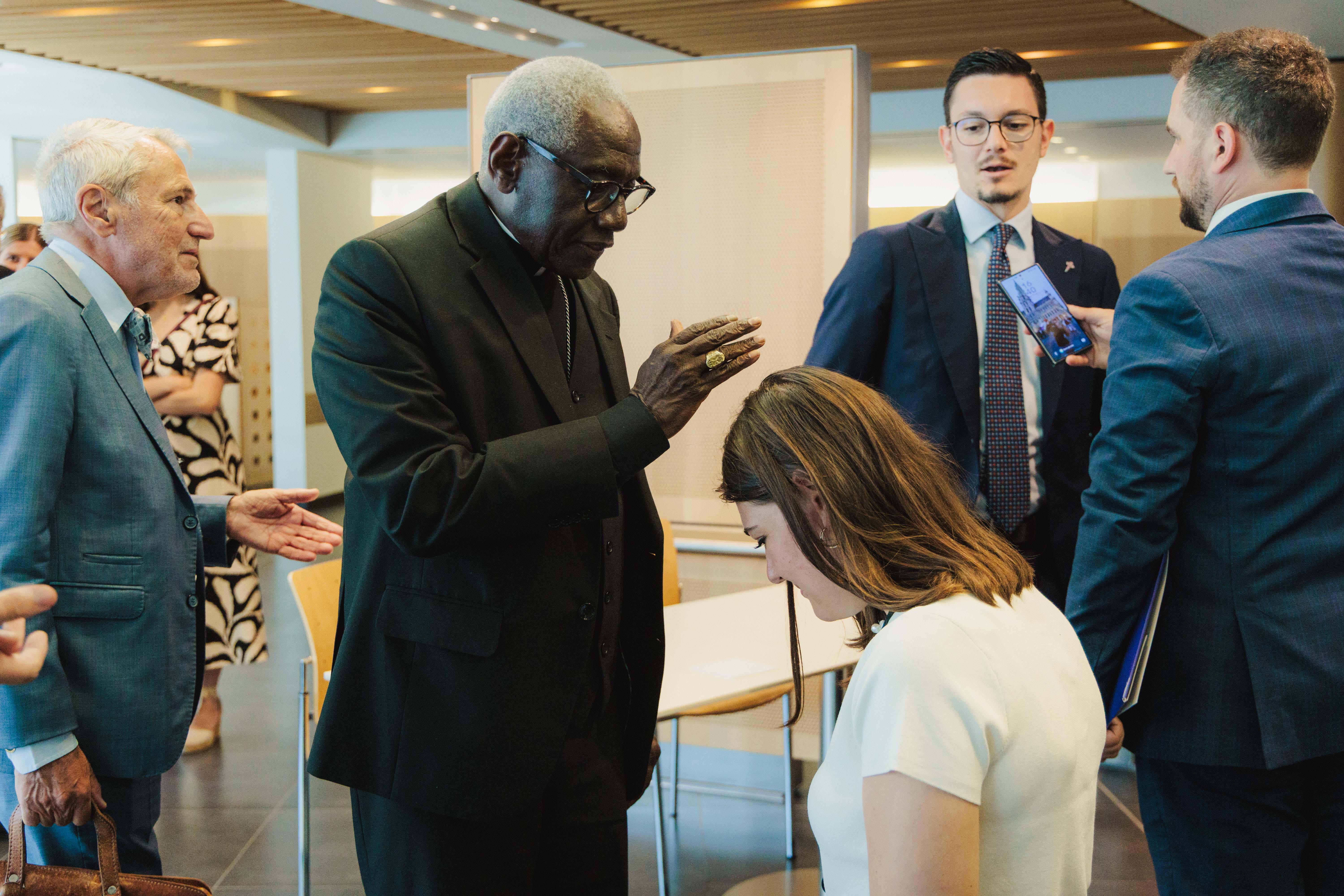 Cardinal Robert Sarah blesses a young woman following the discussion at the European Parliament in Brussels on July 15, 2026. | Credit: ECR Group