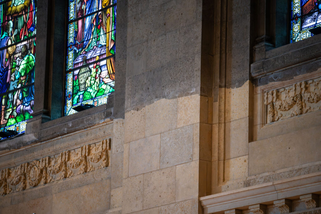 A century’s worth of visible soot and grime contrasts with a restored limestone surface in an undated photograph in the Basilica of Saint Mary, Minneapolis. | Credit: Photo courtesy of the Basilica of Saint Mary