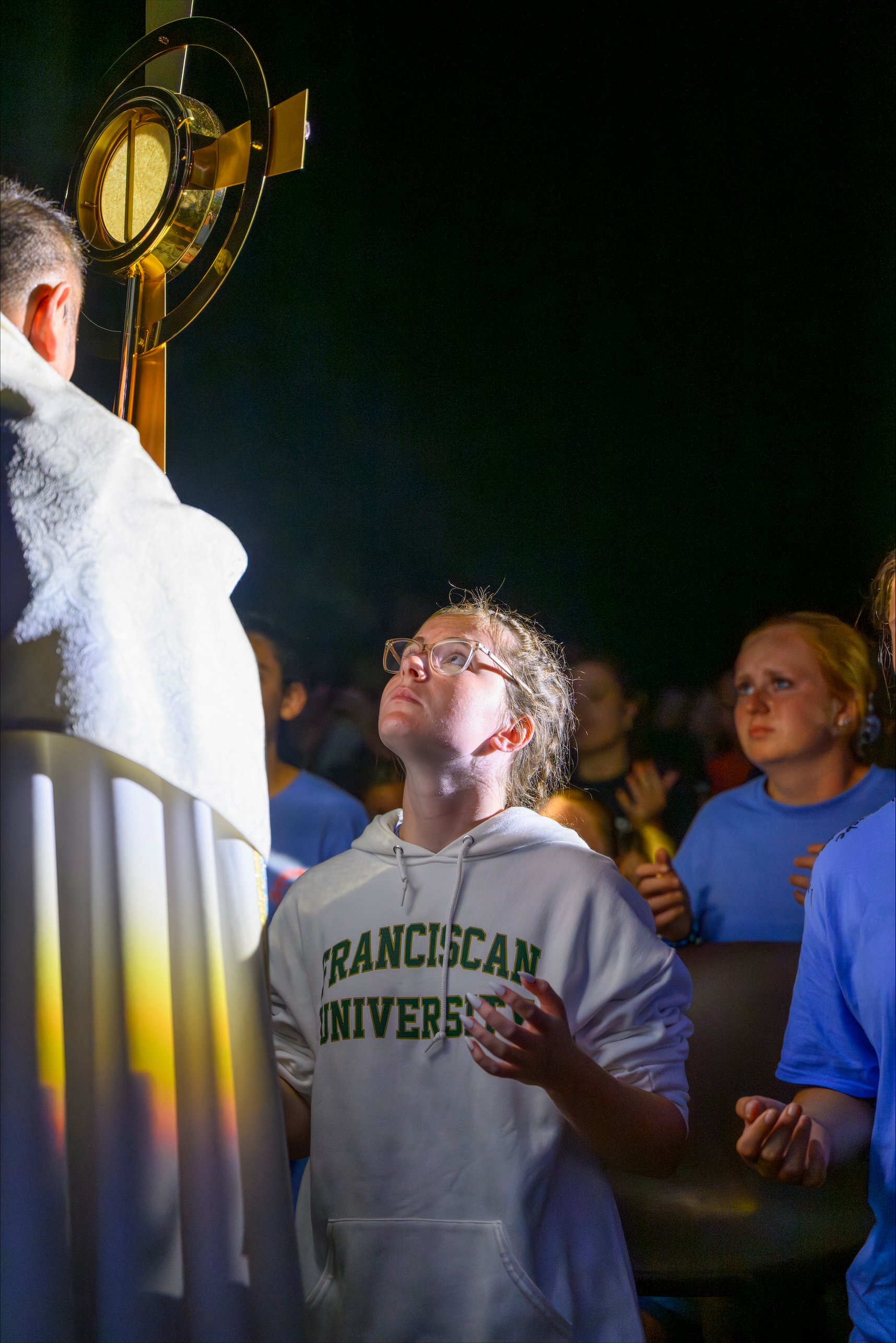 A young woman bows before Jesus in the monstrance during Eucharistic adoration at a Steubenville Youth Conference. | Credit: Franciscan University of Steubenville