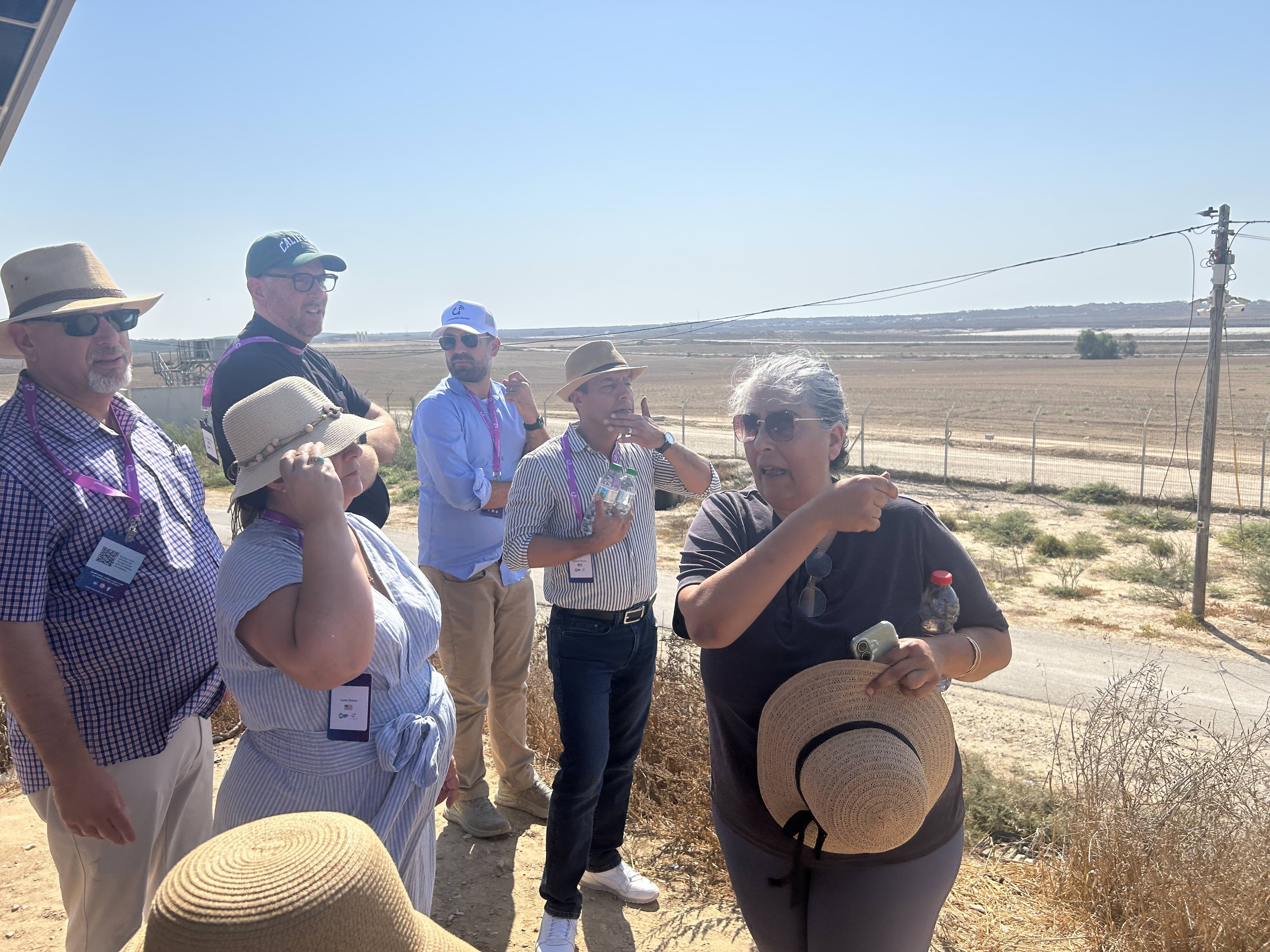 Members of the delegation survey the Gaza Strip, accompanied by Oct. 7, 2023, survivor Oshrit Sabag (pointing over her shoulder) of the neighboring Nahal Oz kibbutz. | Credit: Ken Oliver-Méndez/EWTN News