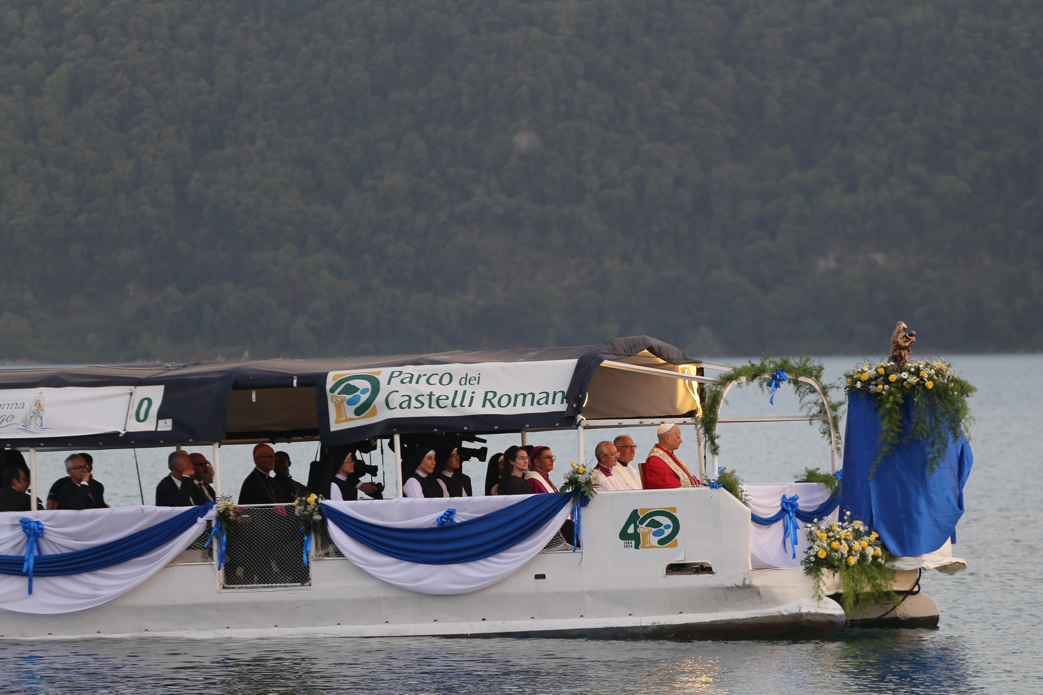 Pope Leo XIV travels across Lake Albano, Castel Gandolfo, Aug. 29, 2026. Leo took part in a Marian procession on the lake, becoming the first pope to travel by boat across the waters there according to the Vatican. | Credit: Zofia Czubak/EWTN News