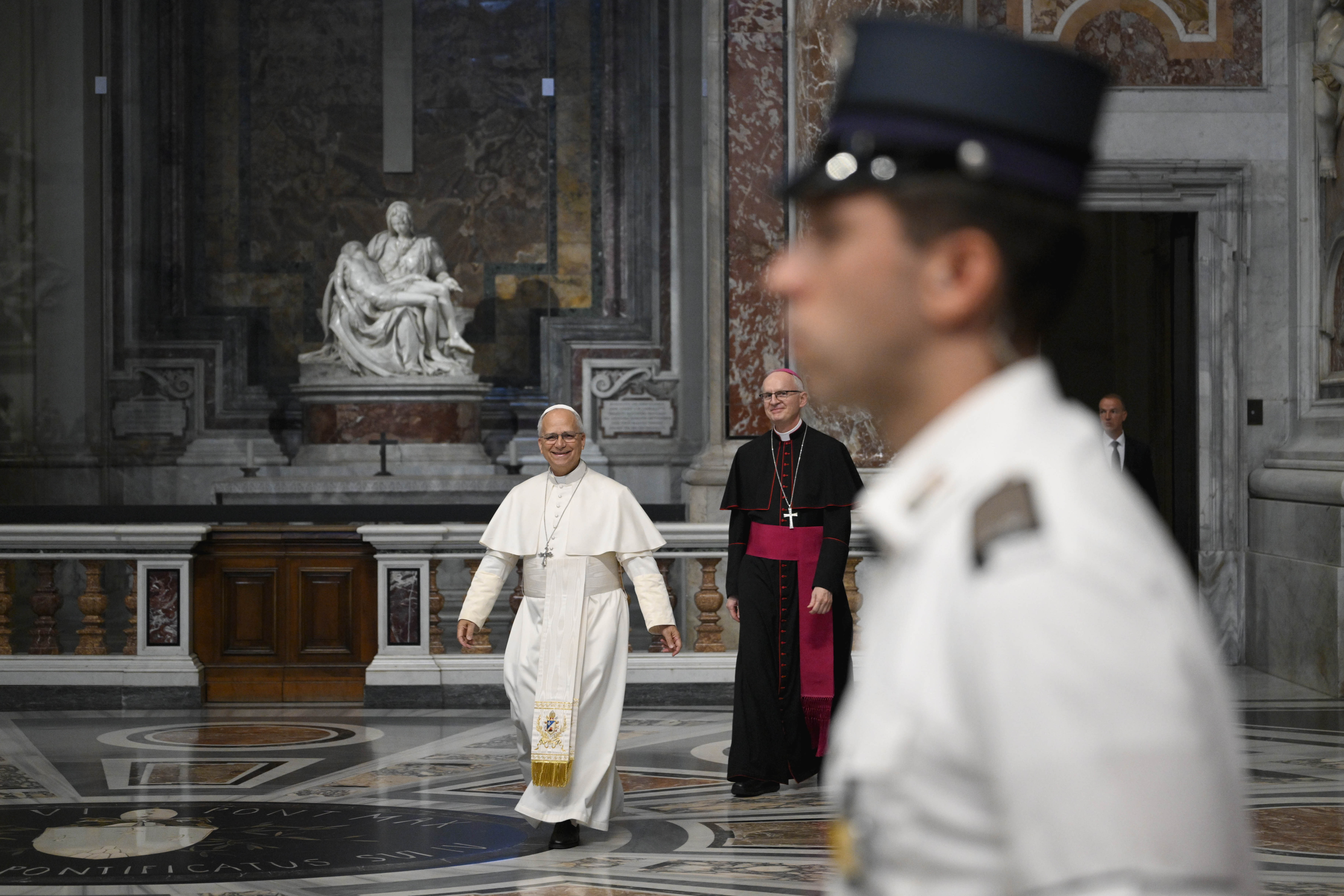 A Vatican gendarme stands guard as Pope Leo XIV walks past Michelangelo’s “Pietà” in St. Peter’s Basilica at the start of his Wednesday general audience on Aug. 19, 2026. | Credit: Vatican Media
