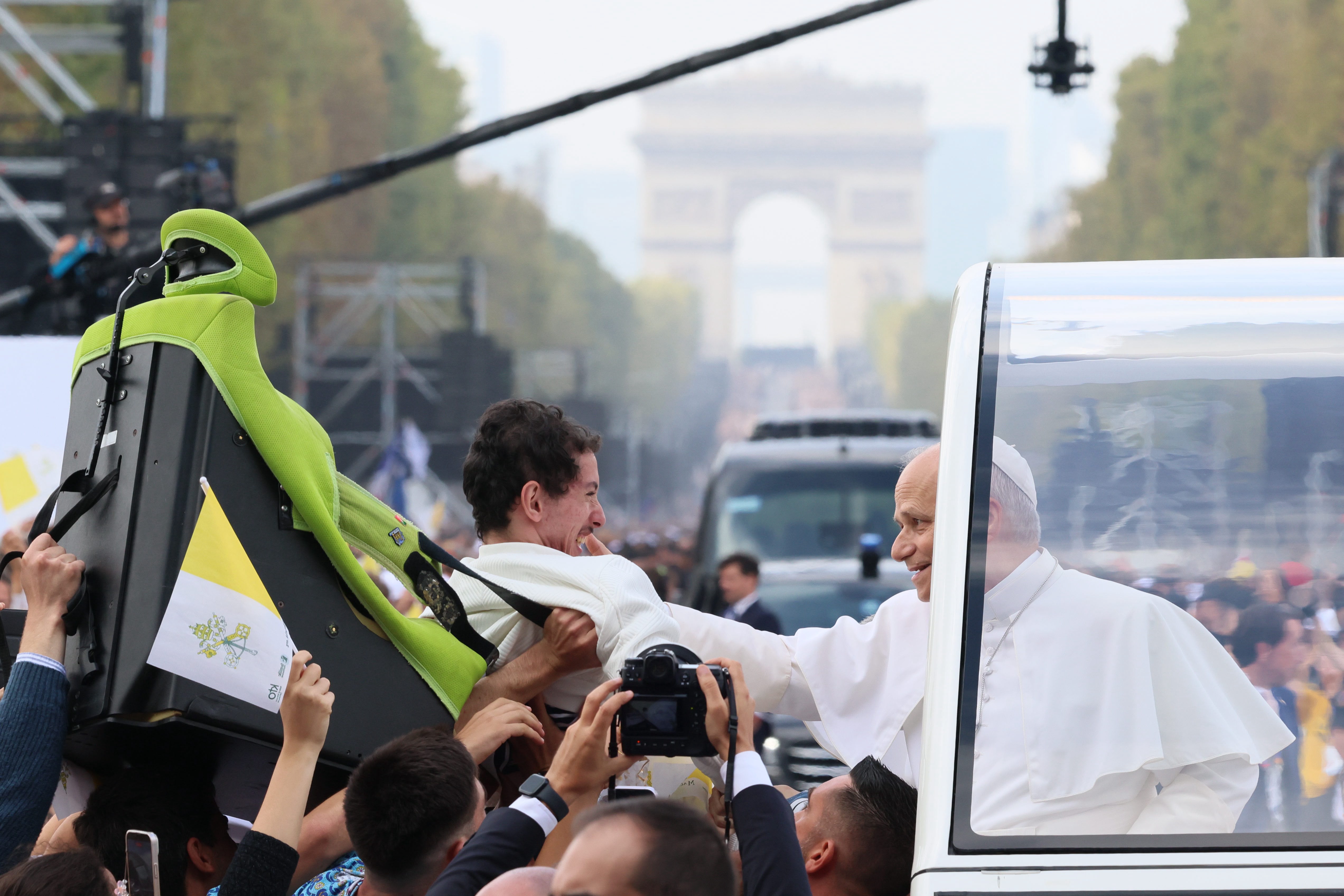 Pope Leo XIV stops to bless a disabled man during his procession to Place de la Concorde to celebrate an open-air Mass on Sept. 26, 2026, in Paris. | Credit: Daniel Ibáñez/EWTN News